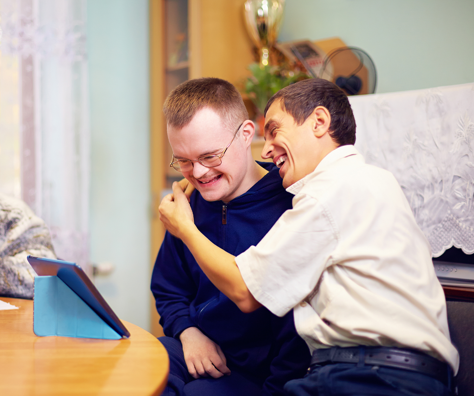 Two people sharing a moment together beside a tablet